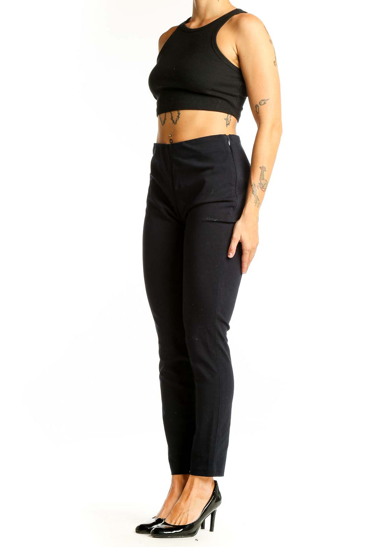 Front view of Uniqlo black ankle-length pants with crop top