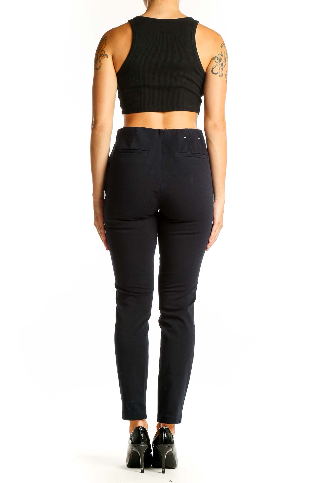 Side view of Uniqlo black ankle-length pants with crop top and heels