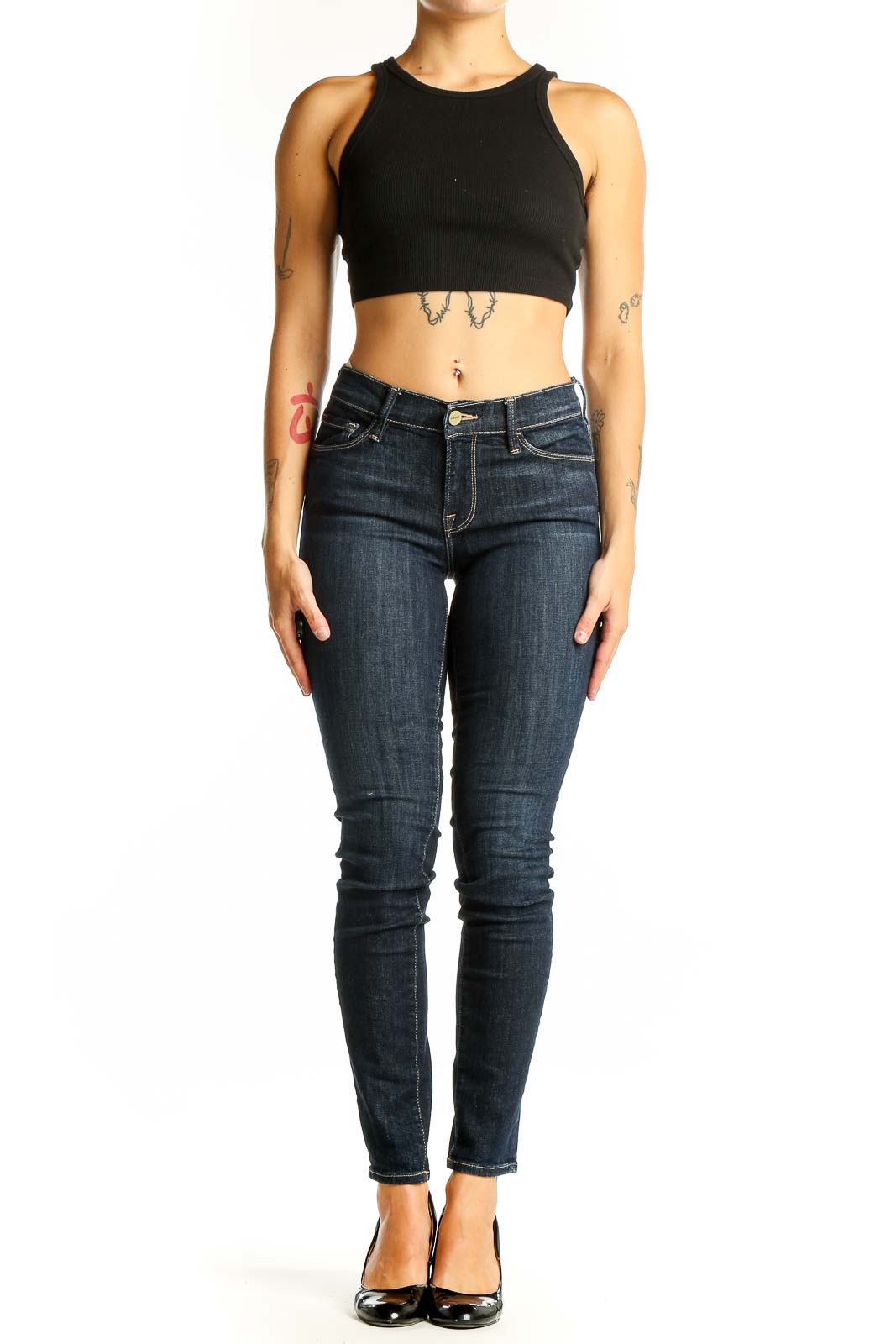 Front view of dark blue FRAME Denim skinny jeans on model