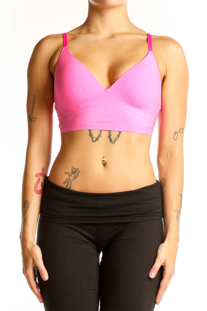 Front view of pink polyester sports bra with V-neck design