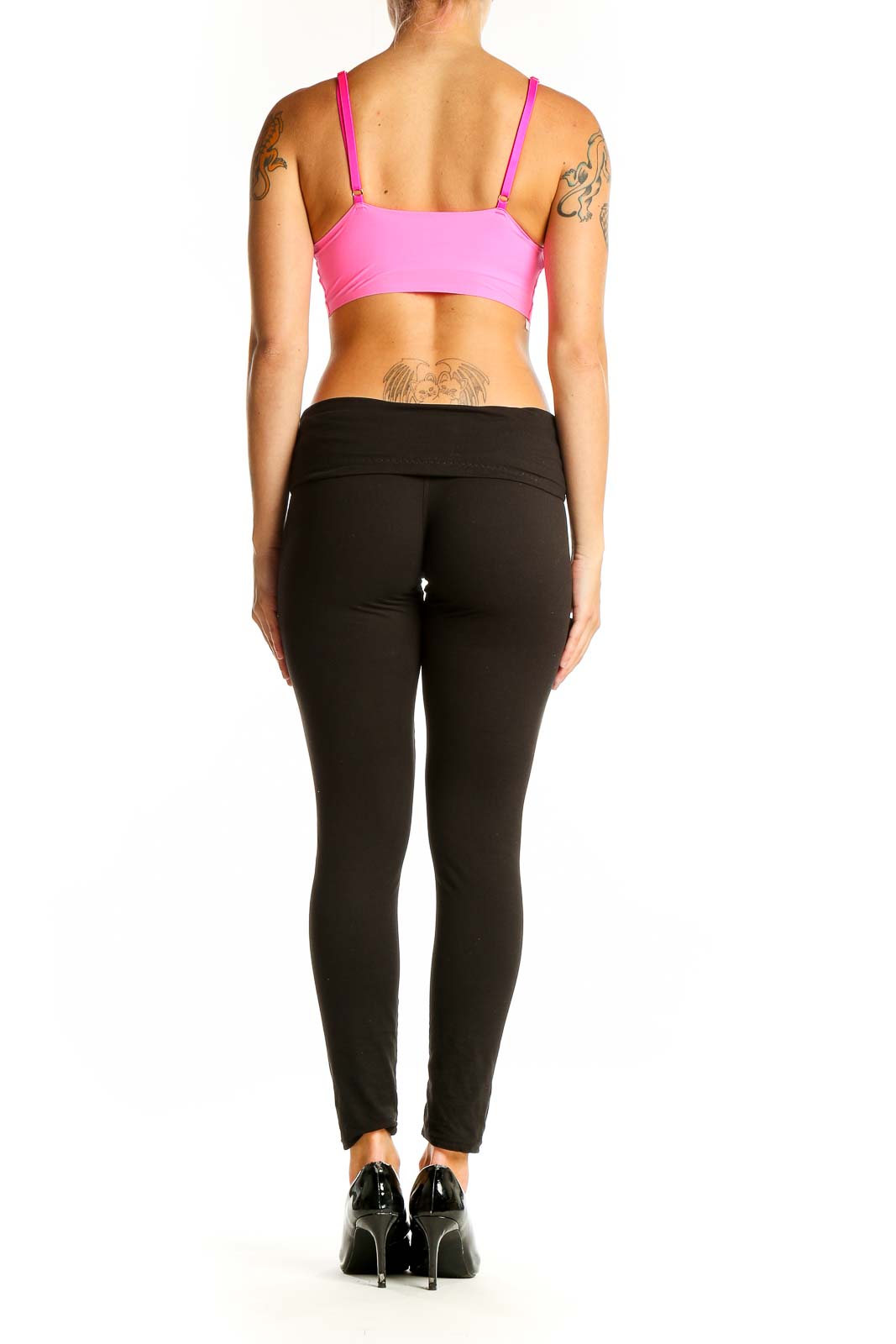 Side view of pink sports bra with black leggings