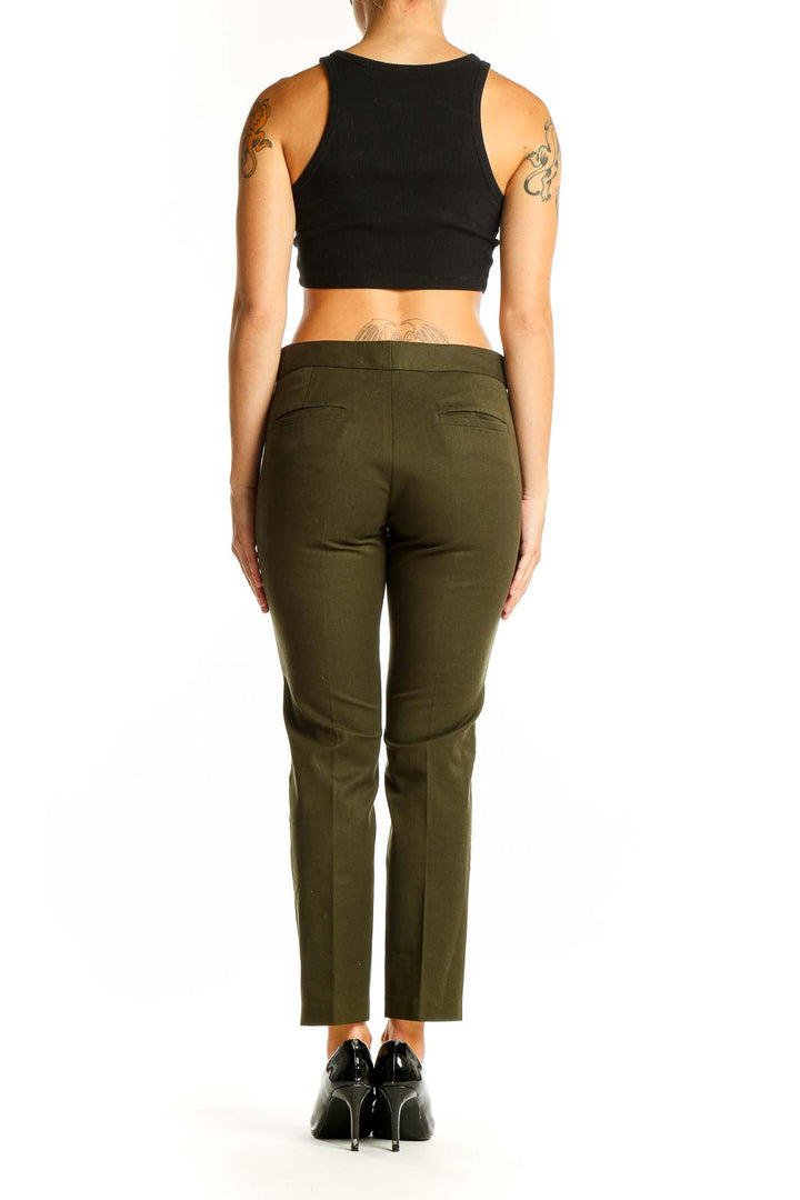 Side view of olive green Banana Republic ankle pants showing side stripes