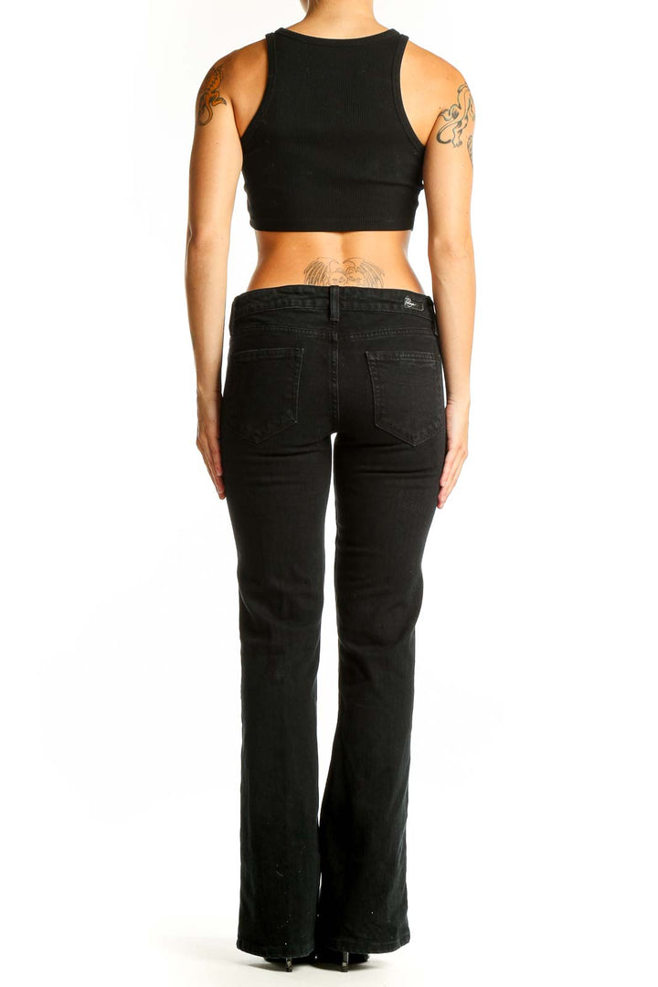 Back view of Paige black slim fit bootcut jeans on model