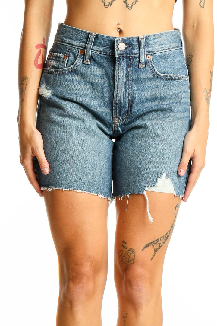 Front view of Gap blue distressed denim shorts with raw hem