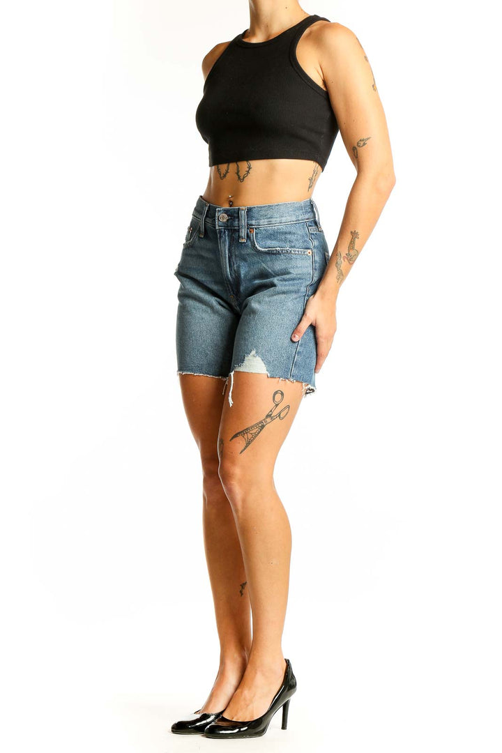 Front view of Gap blue distressed denim shorts with raw hem