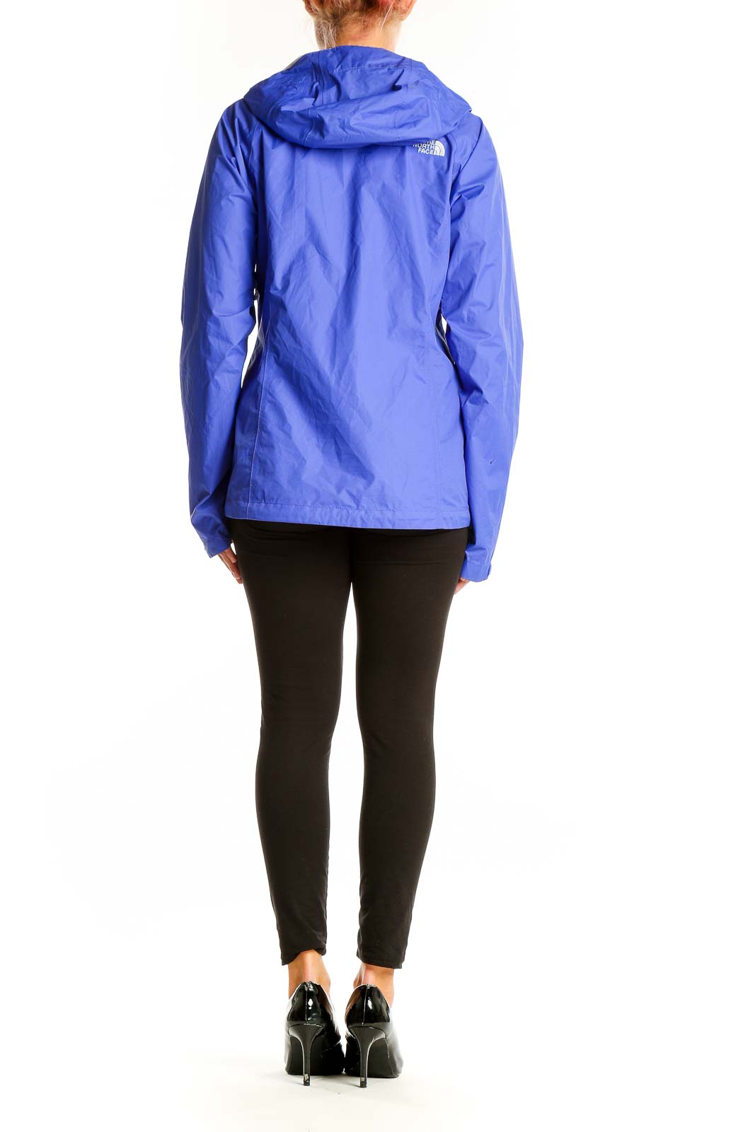 Side view of woman wearing blue The North Face lightweight hooded rain jacket
