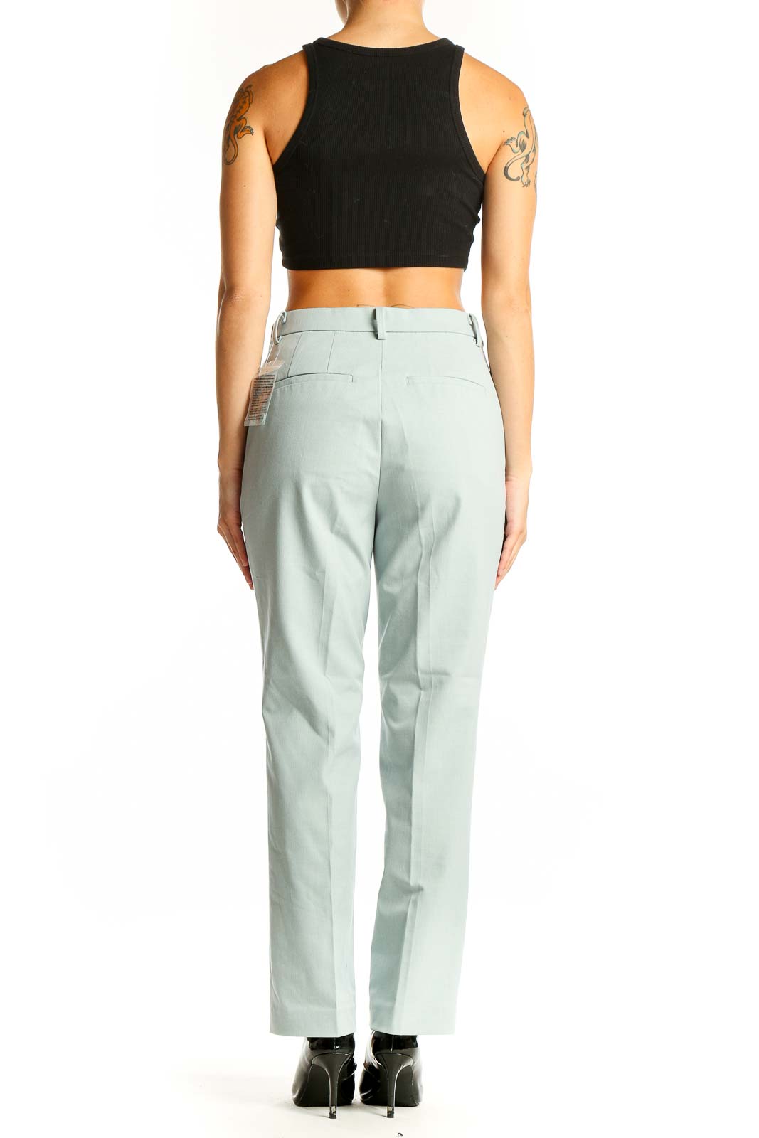 Side view of Uniqlo mint green straight-leg dress pants on model