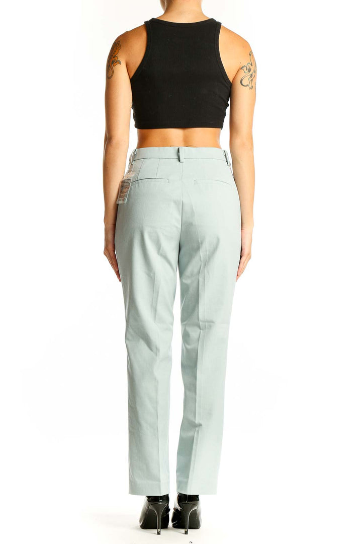 Side view of Uniqlo mint green straight-leg dress pants on model