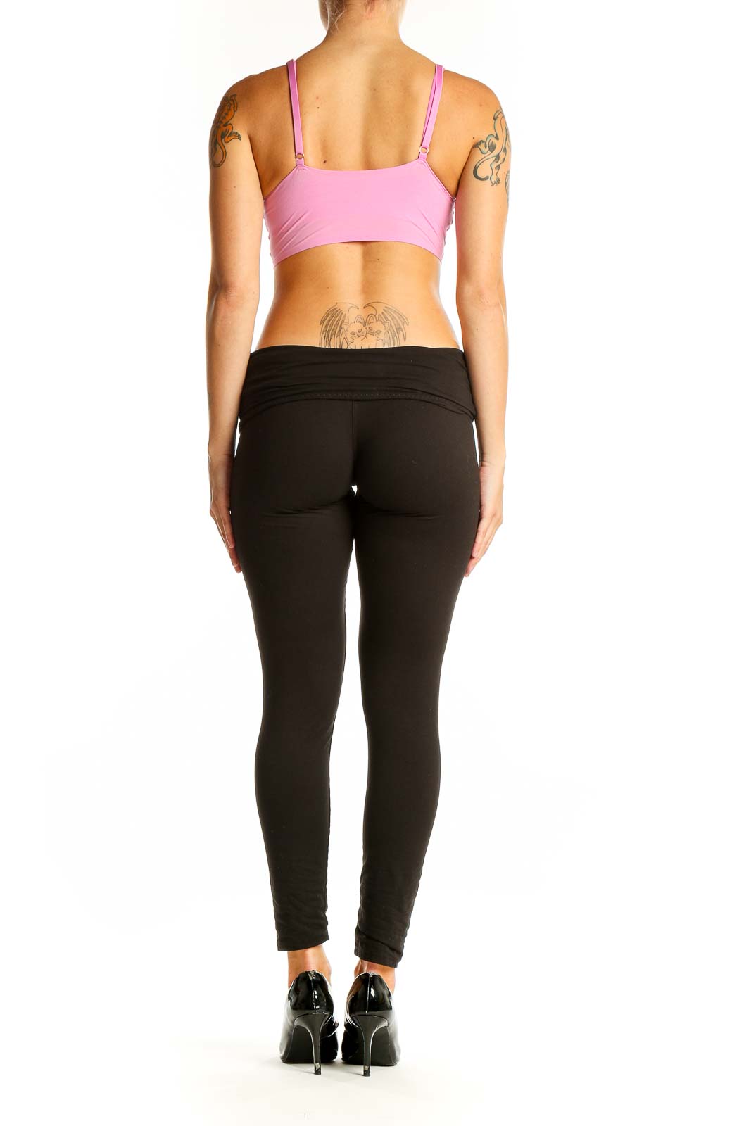 Side view of model wearing pink crop top with black pants