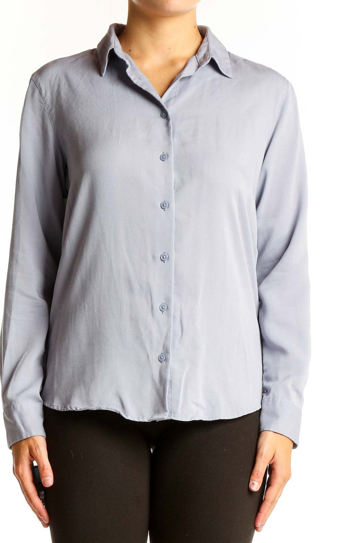 Front view of Uniqlo light blue button-up long sleeve shirt
