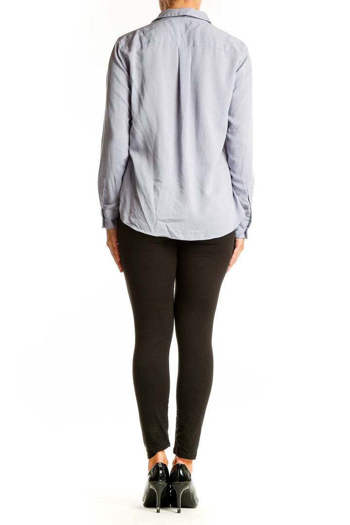 Back view of Uniqlo light blue button-up long sleeve shirt on model