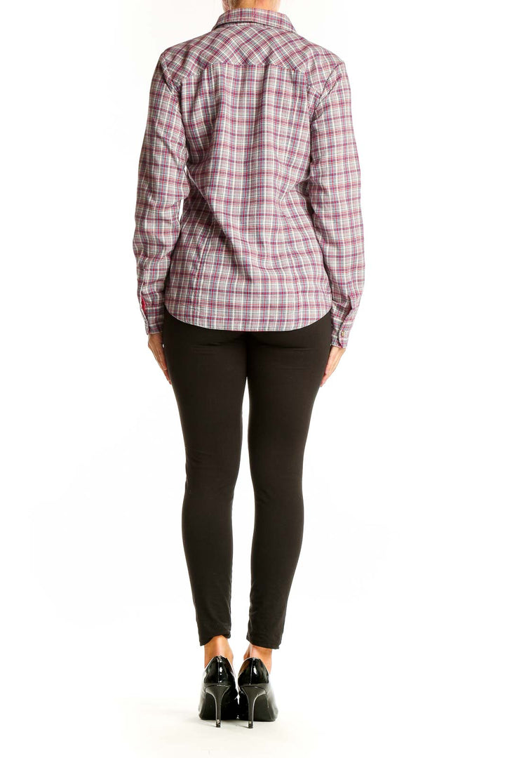 Side view of woman wearing Orvis pink plaid polyester button-up shirt with black pants