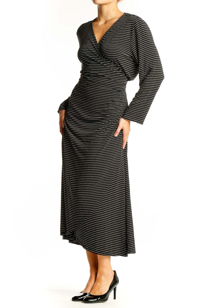 Front view of Gap black striped wrap midi dress with V-neck