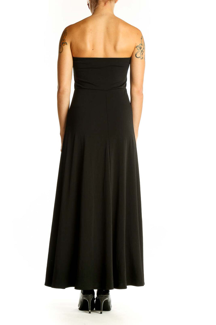 Side view of black strapless maxi dress showing full length
