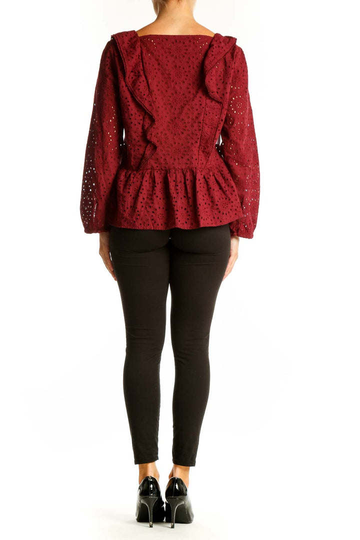 Side view of Madewell burgundy eyelet lace peplum blouse showing long balloon sleeves and peplum waist