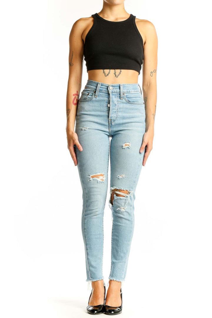 Front view of Levi's light blue distressed high-waisted skinny jeans