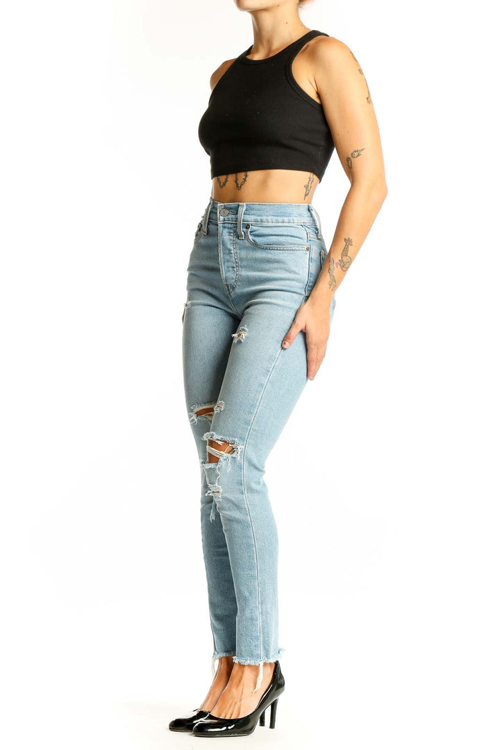 Front view of Levi's light blue distressed high-waisted skinny jeans