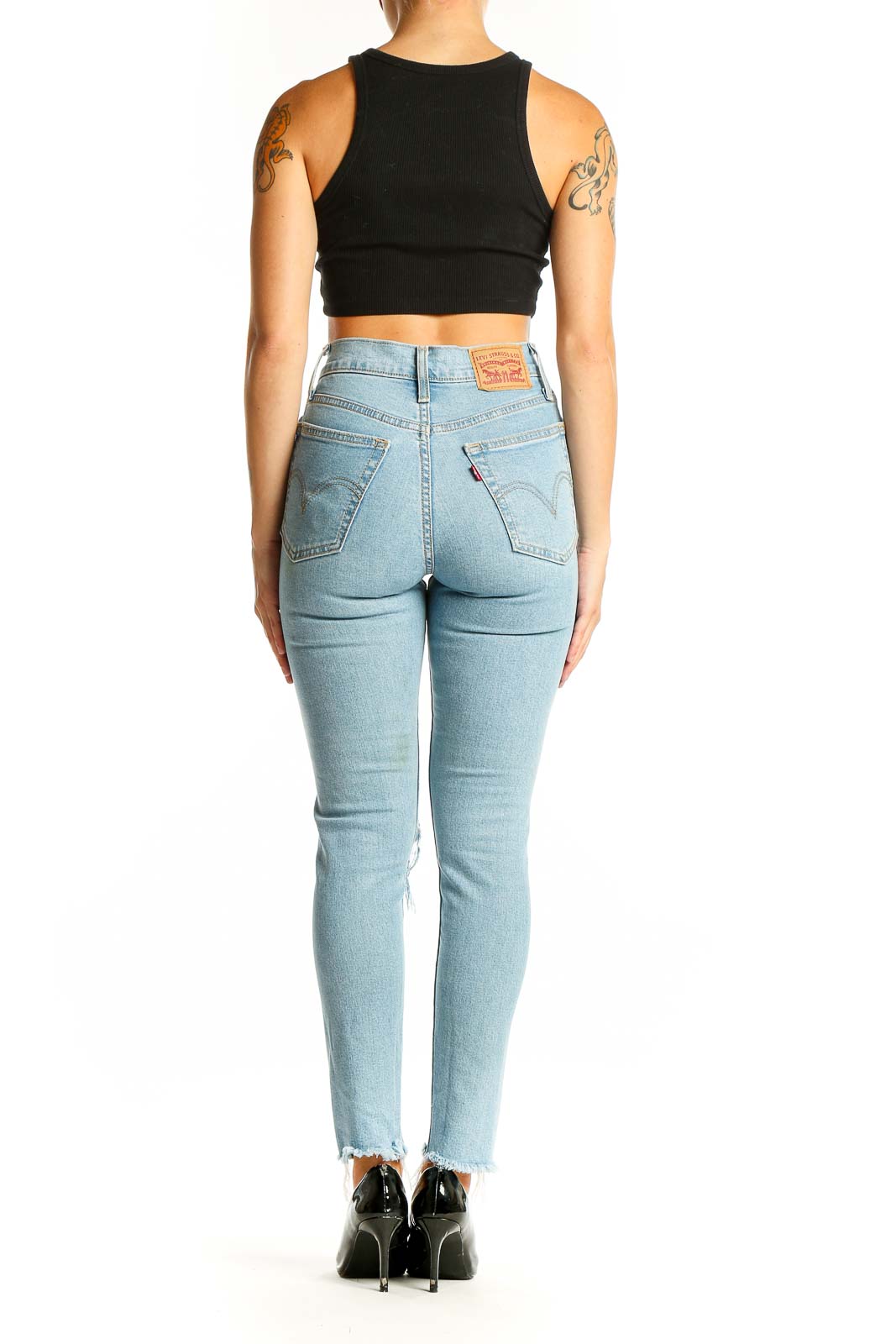 Side view of Levi's light blue distressed high-waisted skinny jeans