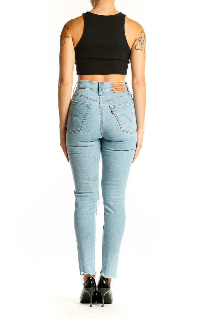 Side view of Levi's light blue distressed high-waisted skinny jeans