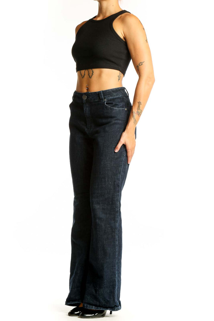 Front view of Cabi dark blue wide-leg jeans on model