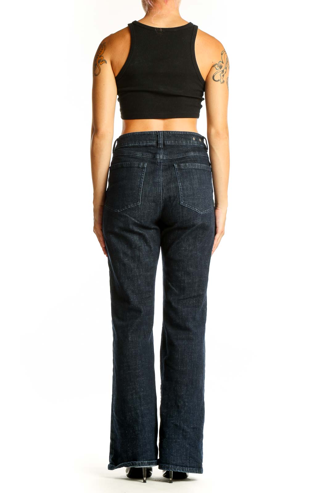 Side view of Cabi dark blue wide-leg jeans on model