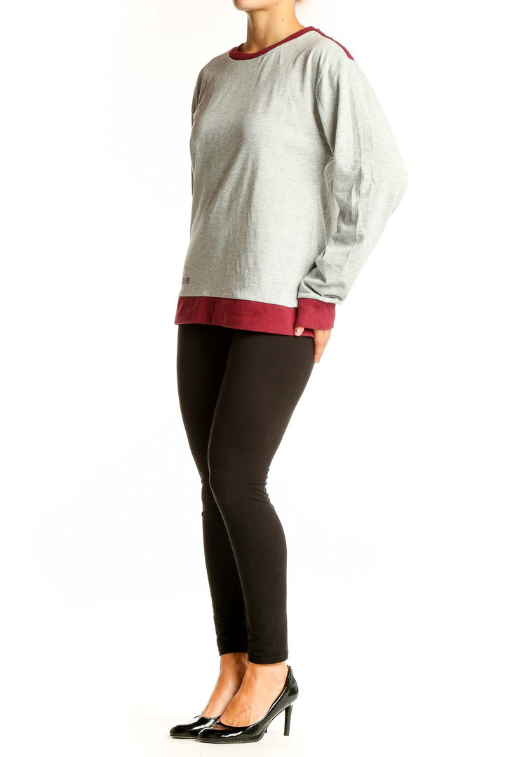 Front view of Jason Wu gray long sleeve top with burgundy trim