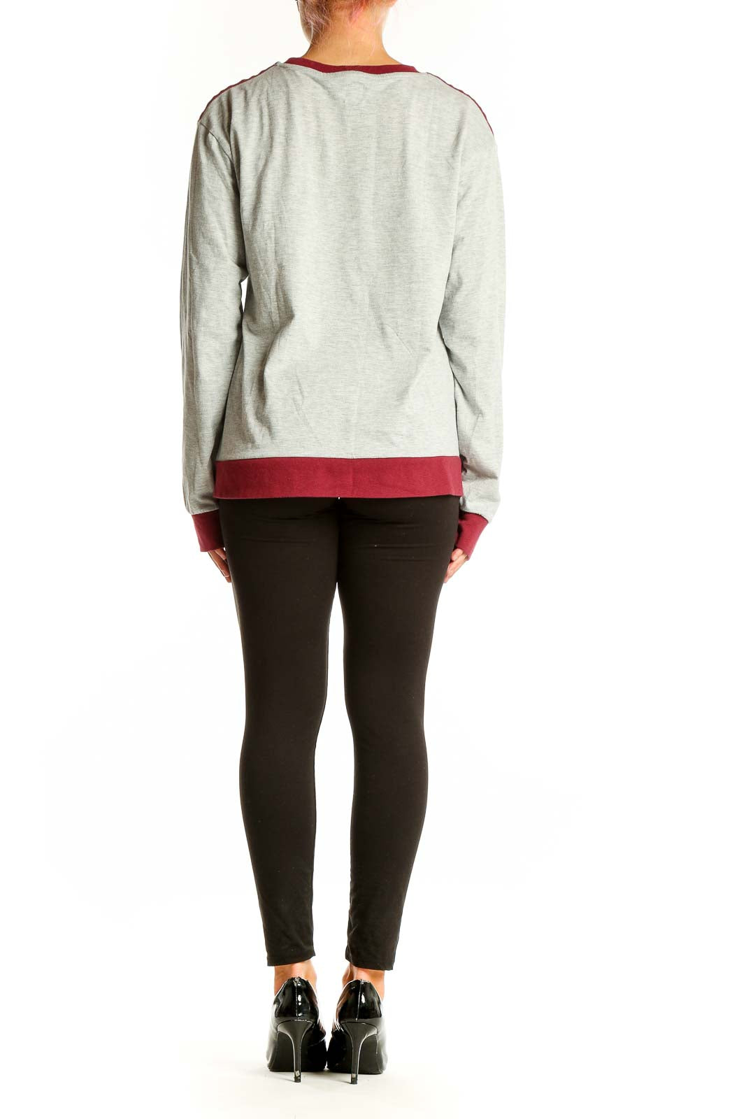 Side view of model wearing Jason Wu gray long sleeve top with black pants