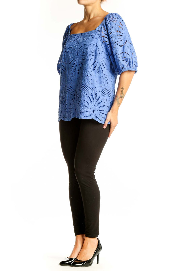 Front view of blue eyelet lace cotton blouse with square neckline and puffed sleeves