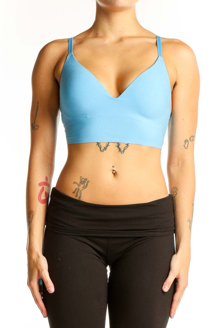 Front view of sky blue Pink Victoria's Secret sports bra with V-neck design