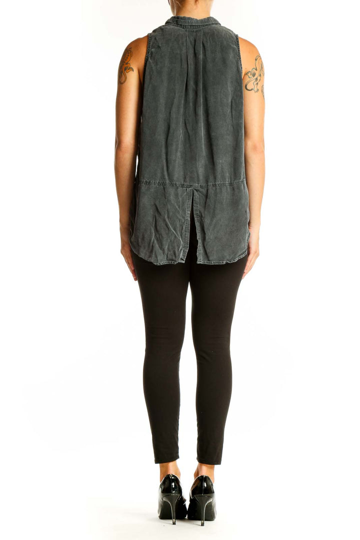 Side view of model wearing gray sleeveless button-up top by cloth & stone with black pants