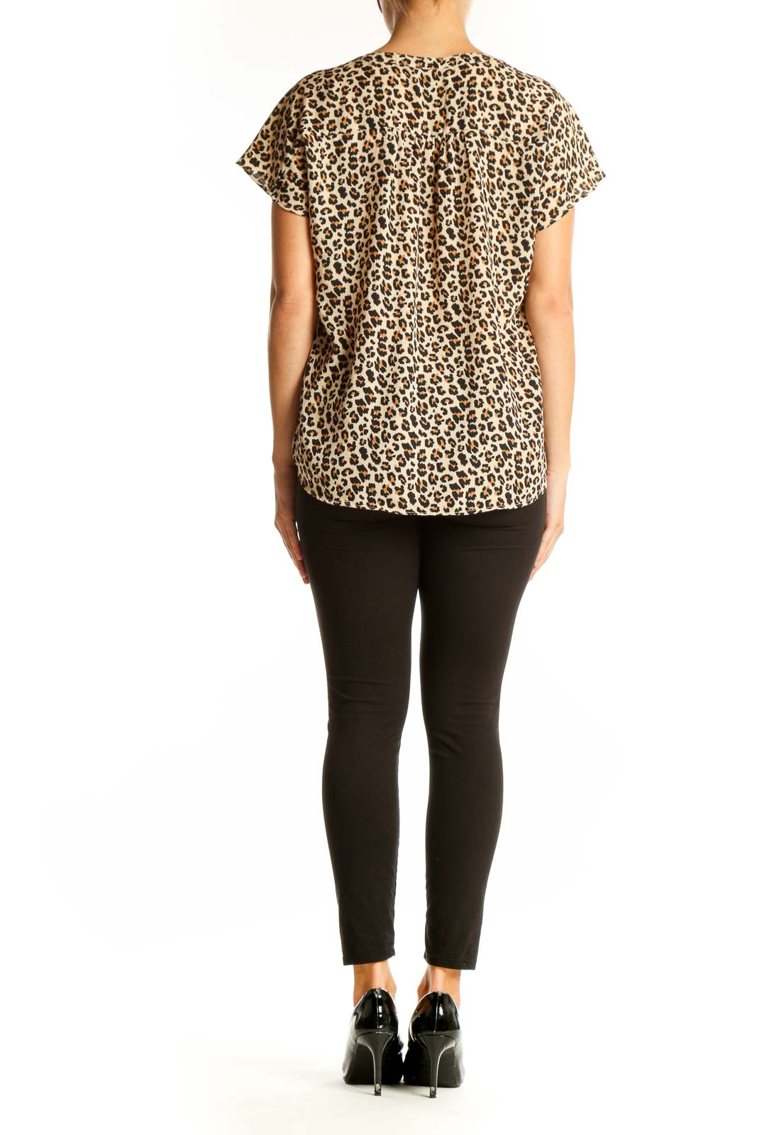 Side view of model wearing Banana Republic beige leopard print blouse with black pants