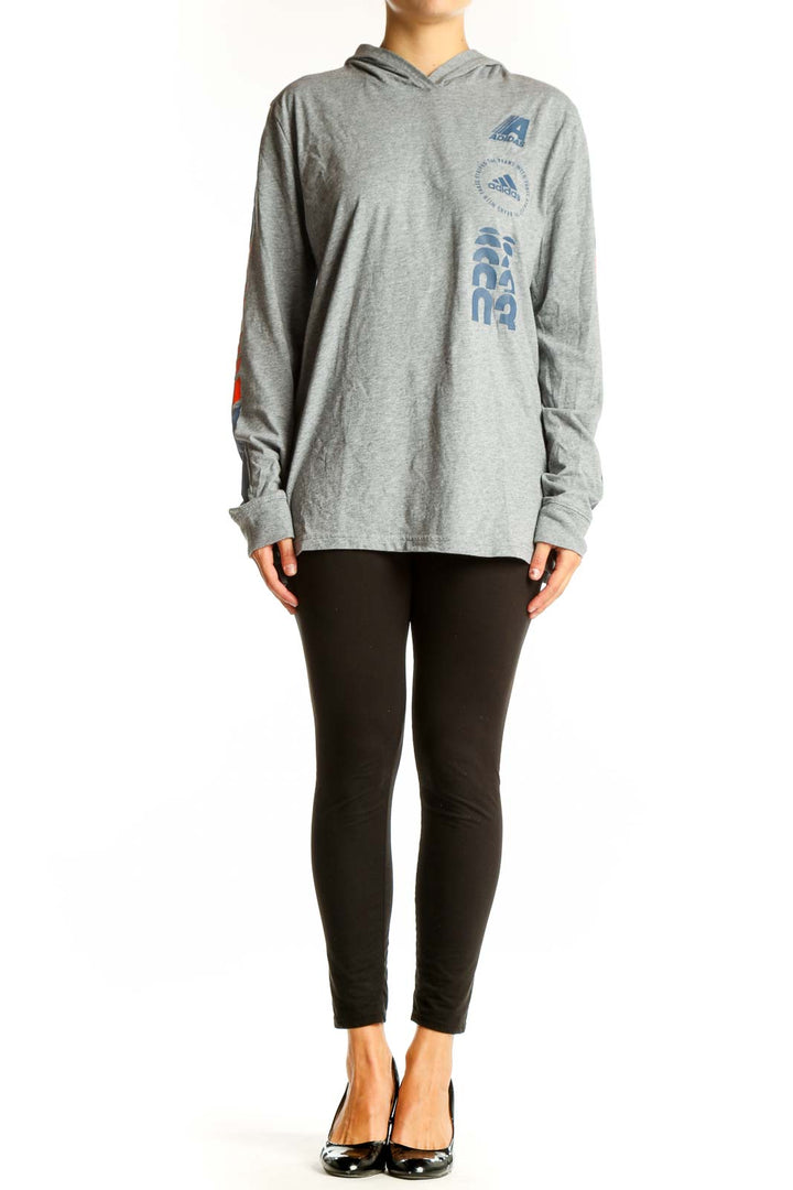 Front view of gray Adidas hooded long sleeve top with blue and orange graphics