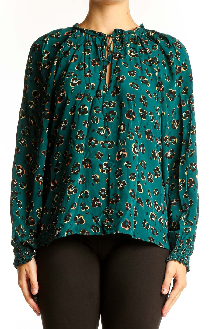 Front view of teal leopard print blouse with long sleeves and keyhole neckline