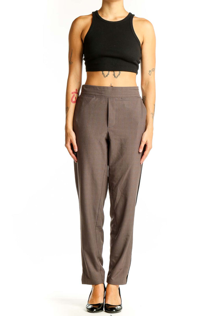 Front view of brown Athleta athletic pants with side stripes
