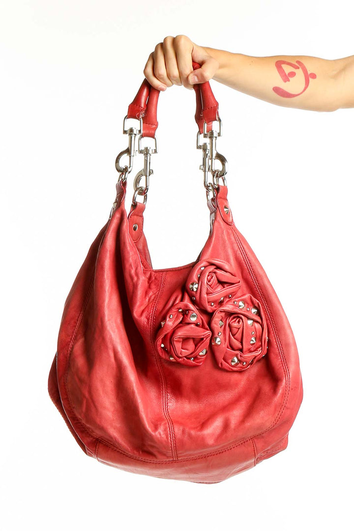 Front view of red leather Betsey Johnson hobo bag with floral accents