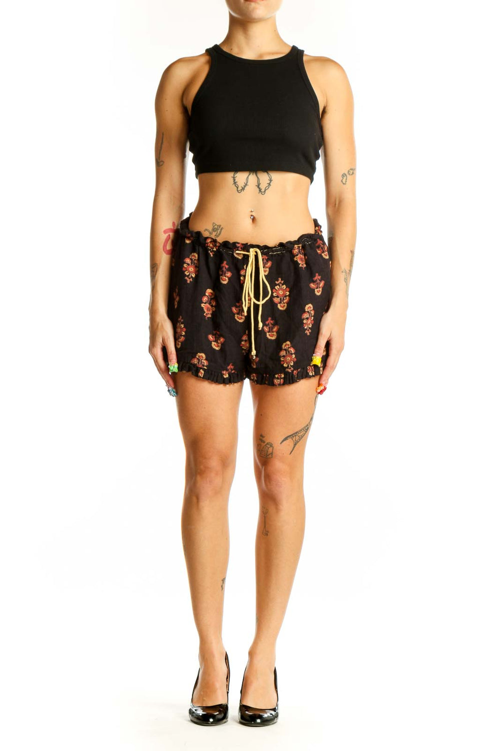 Front view of Free People black floral print cotton shorts with drawstring waist