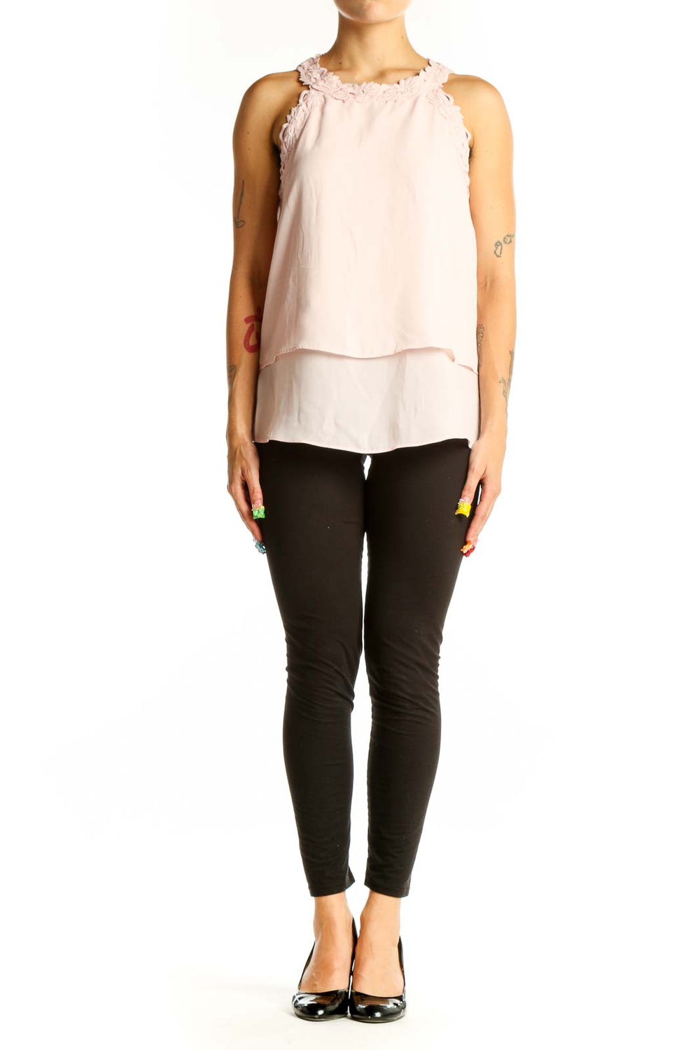 Front view of light pink layered sleeveless blouse with ruffle neckline