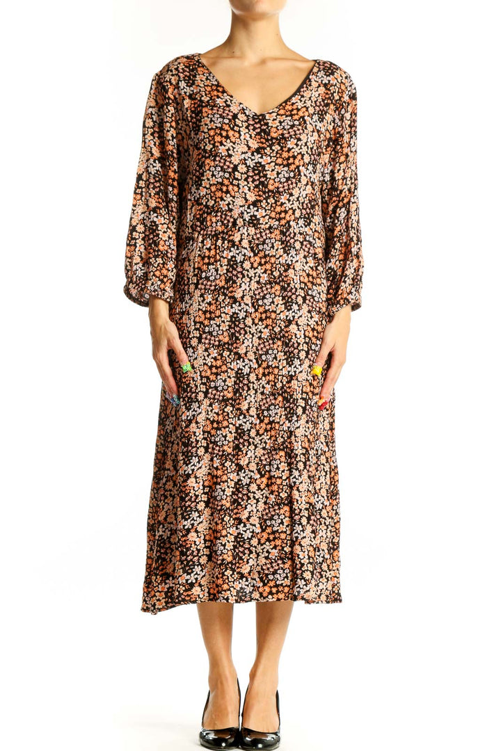 Front view of brown floral midi dress with V-neck and balloon sleeves