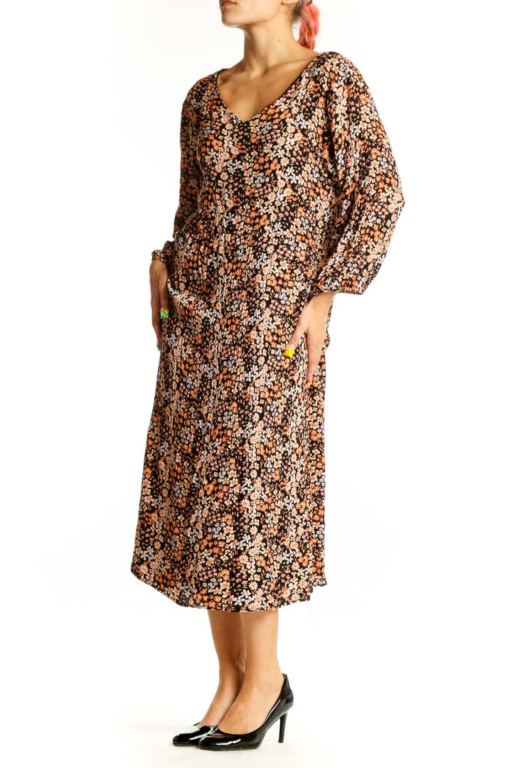 Front view of brown floral midi dress with V-neck and balloon sleeves