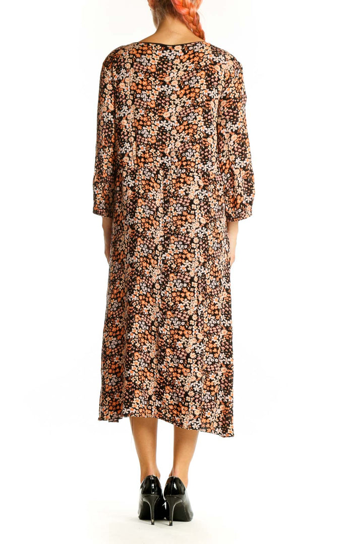 Side view of brown floral midi dress showing flowing silhouette