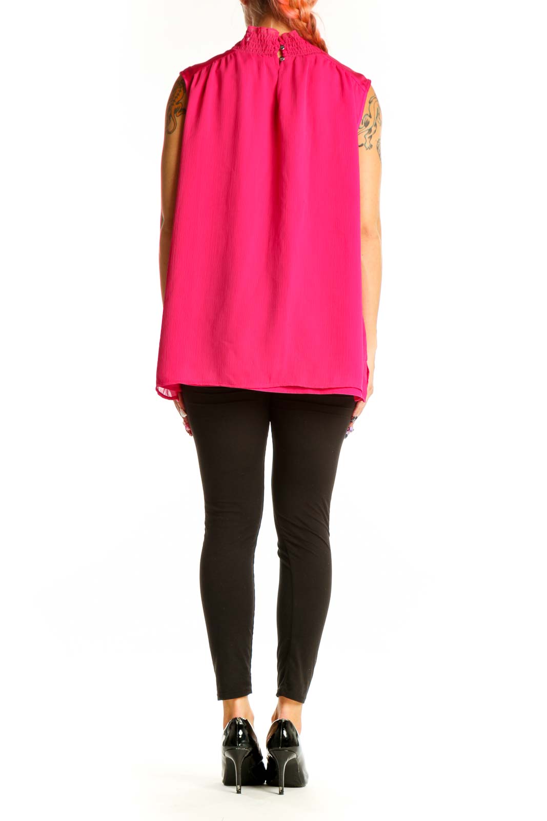 Back view of hot pink DKNY sleeveless mock neck blouse on model