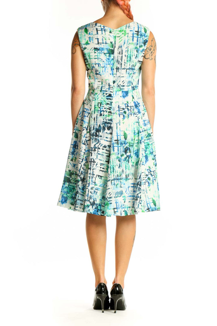 Side view of Shesmiss blue and green abstract print sleeveless dress
