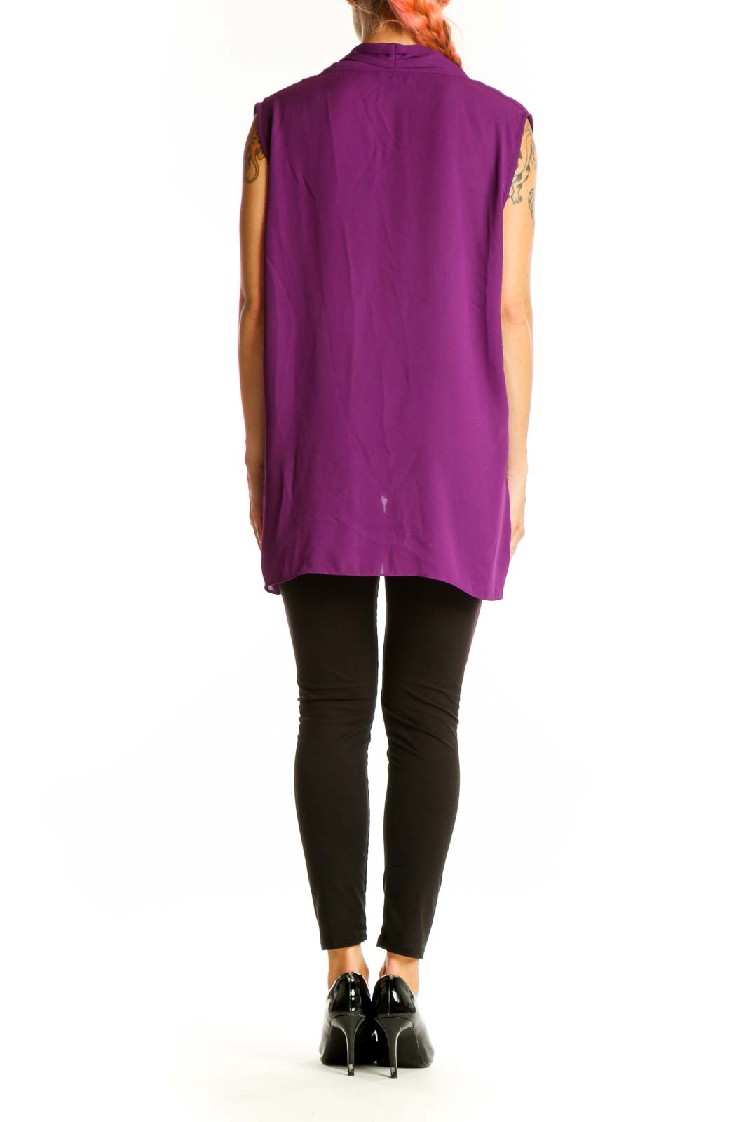 Side view of model wearing purple draped sleeveless blouse by Vince Camuto with black pants