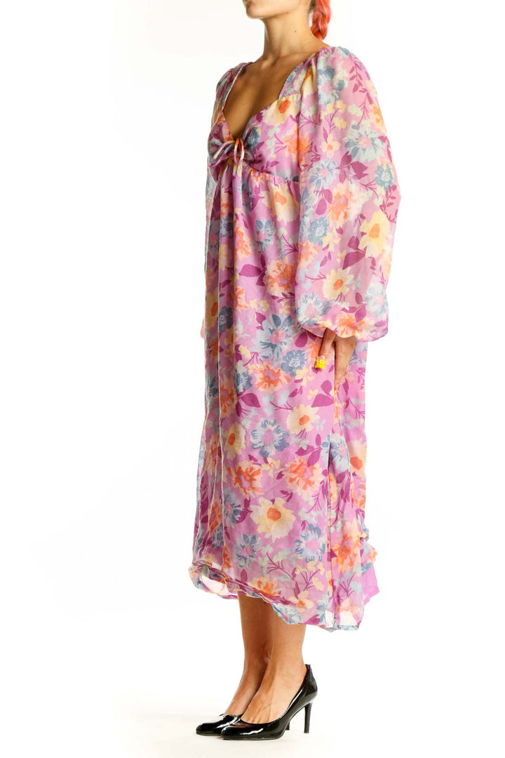 Front view of pink floral Billabong chiffon maxi dress with long sleeves and V-neckline