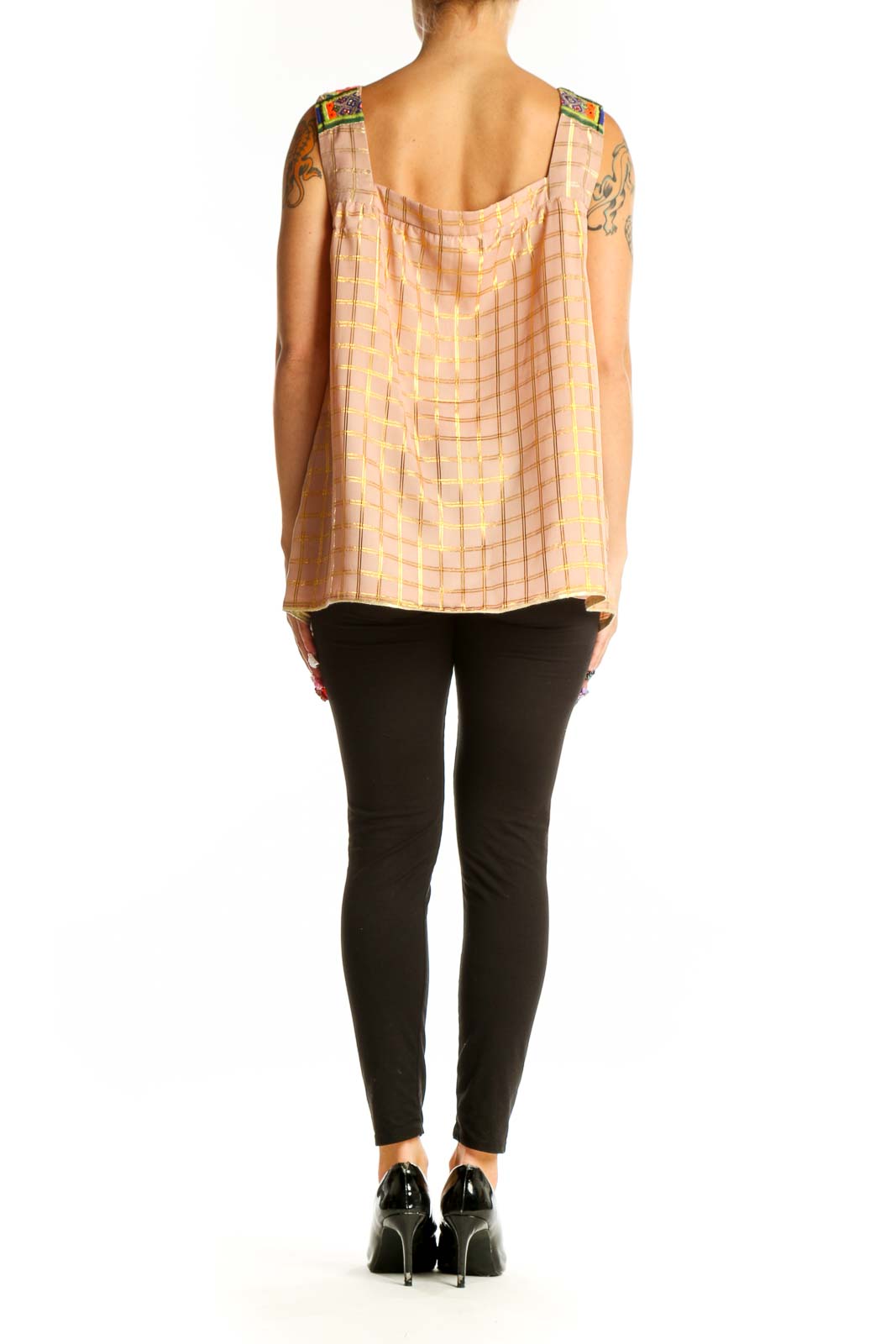 Side view of model wearing Vineet Bahl pink plaid sleeveless top with black pants