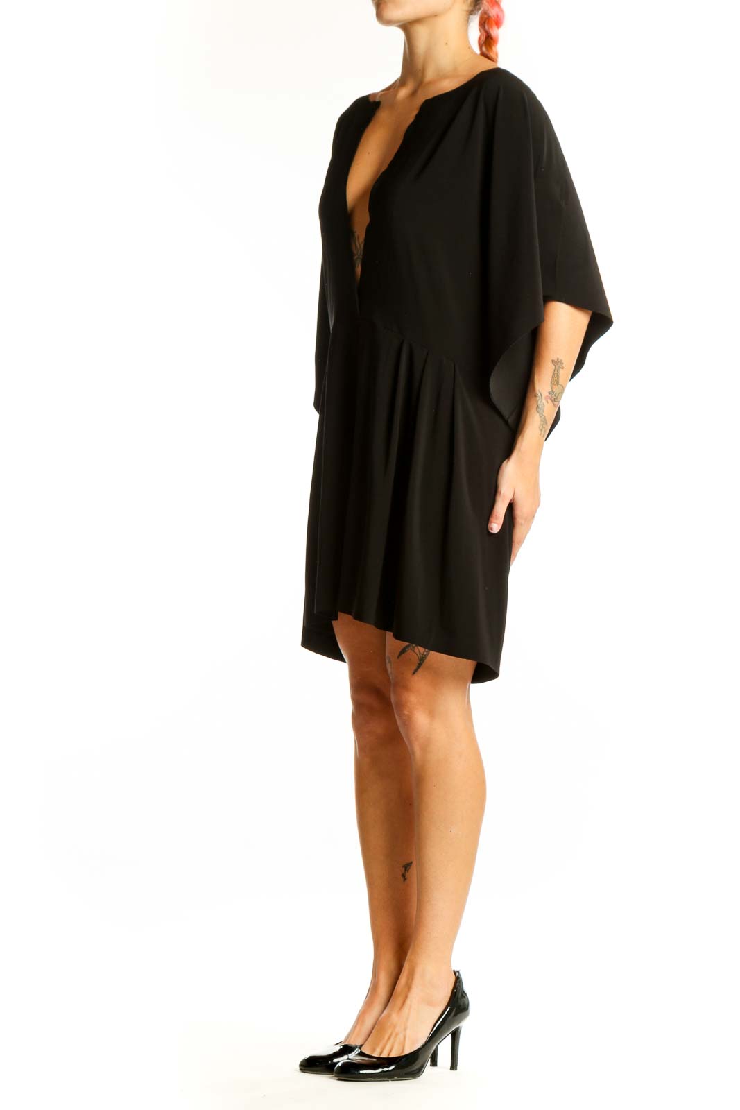 Front view of black NORMA KAMALI mini dress with plunging V-neck