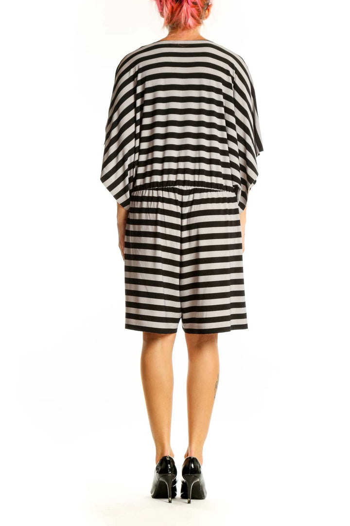 Side view of NORMA KAMALI Black and White Striped Plunge Neck Dress showing kimono sleeves