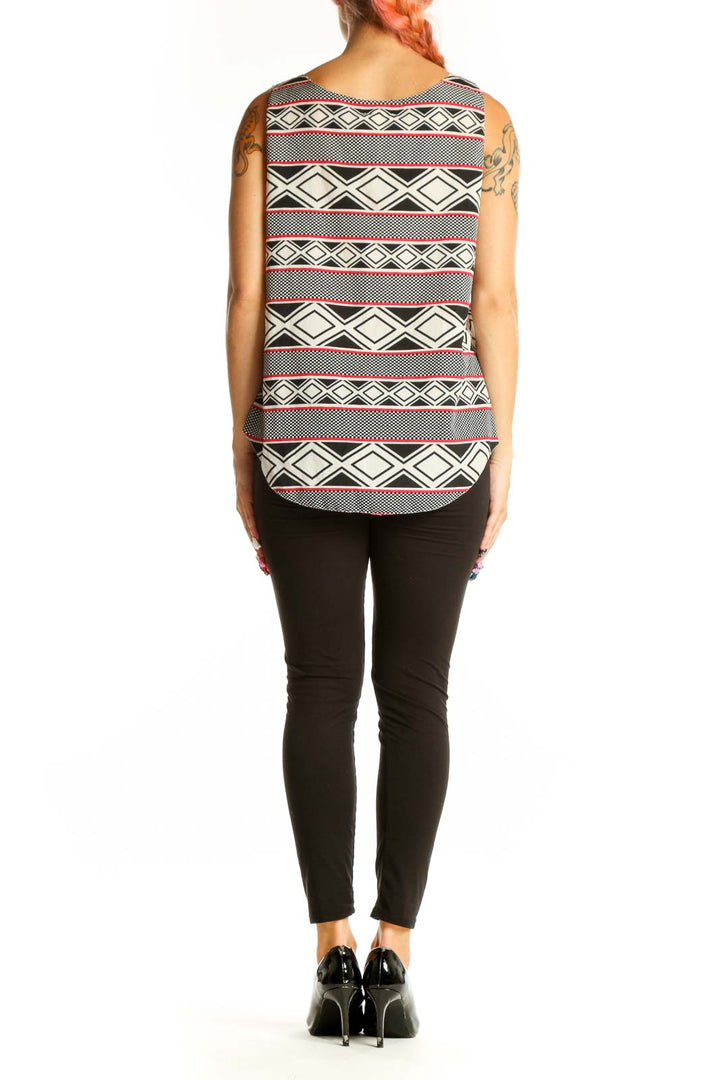 Side view of model wearing Aryn K black and white geometric print sleeveless top with black pants