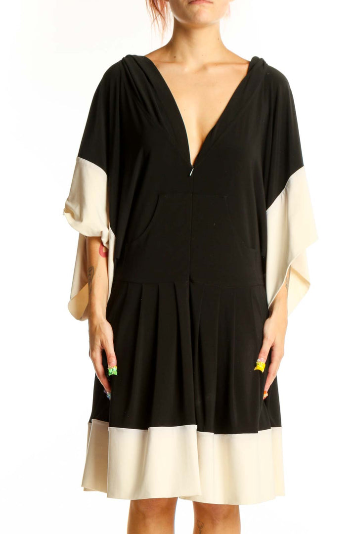 Front view of NORMA KAMALI black and cream color-block dress with V-neck and batwing sleeves