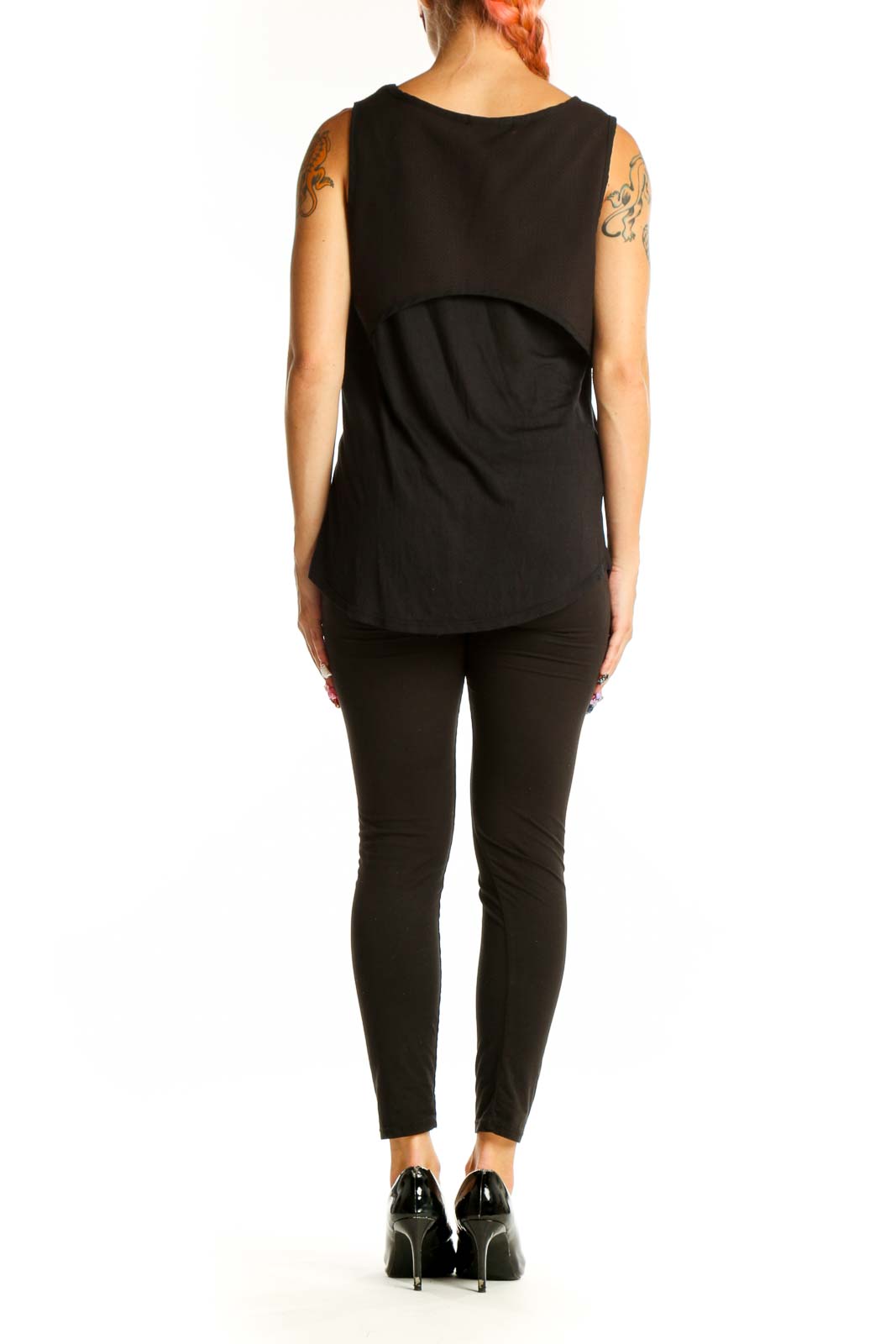Side view of woman wearing black Harlowe & Graham tank top with black pants